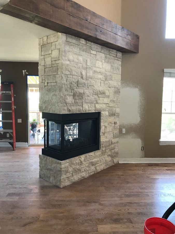 See-through fireplace wrapped in stone