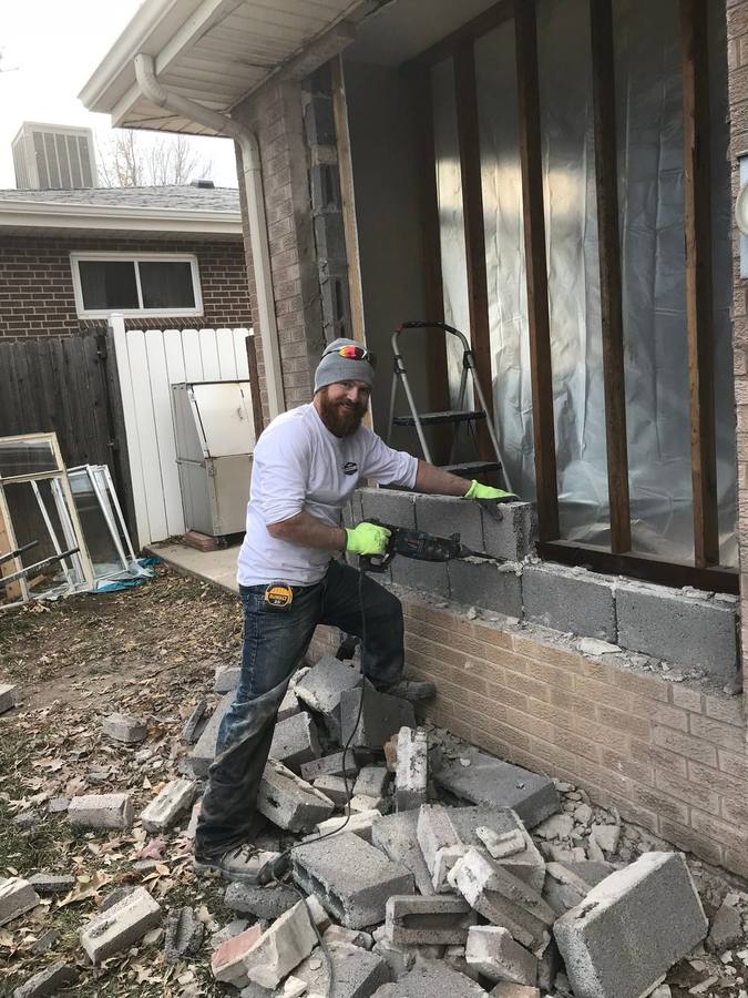 Mason setting stone on a foundation wall